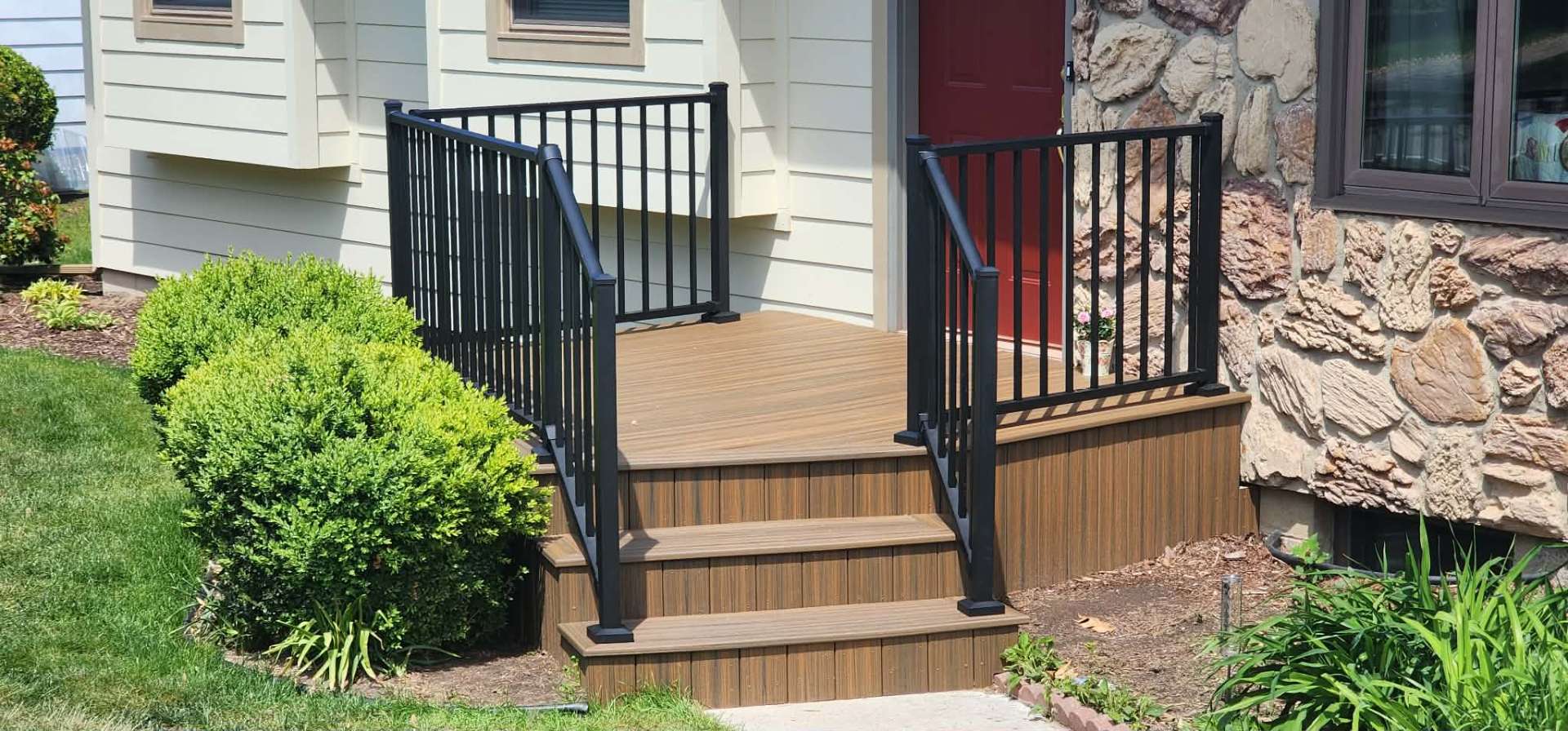 Renovated front porch with composite decking and custom railings